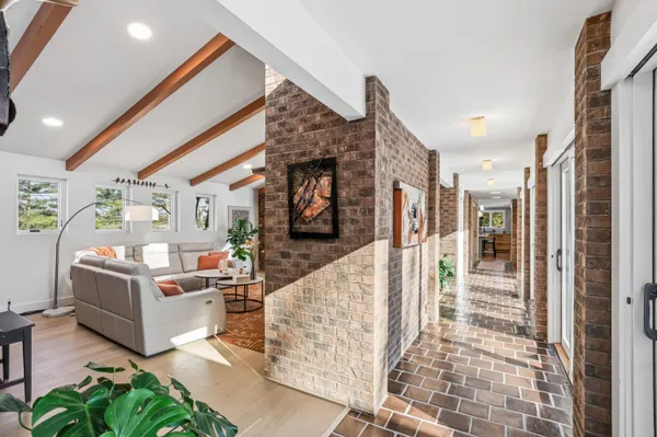 a living room with fireplace furniture and a rug