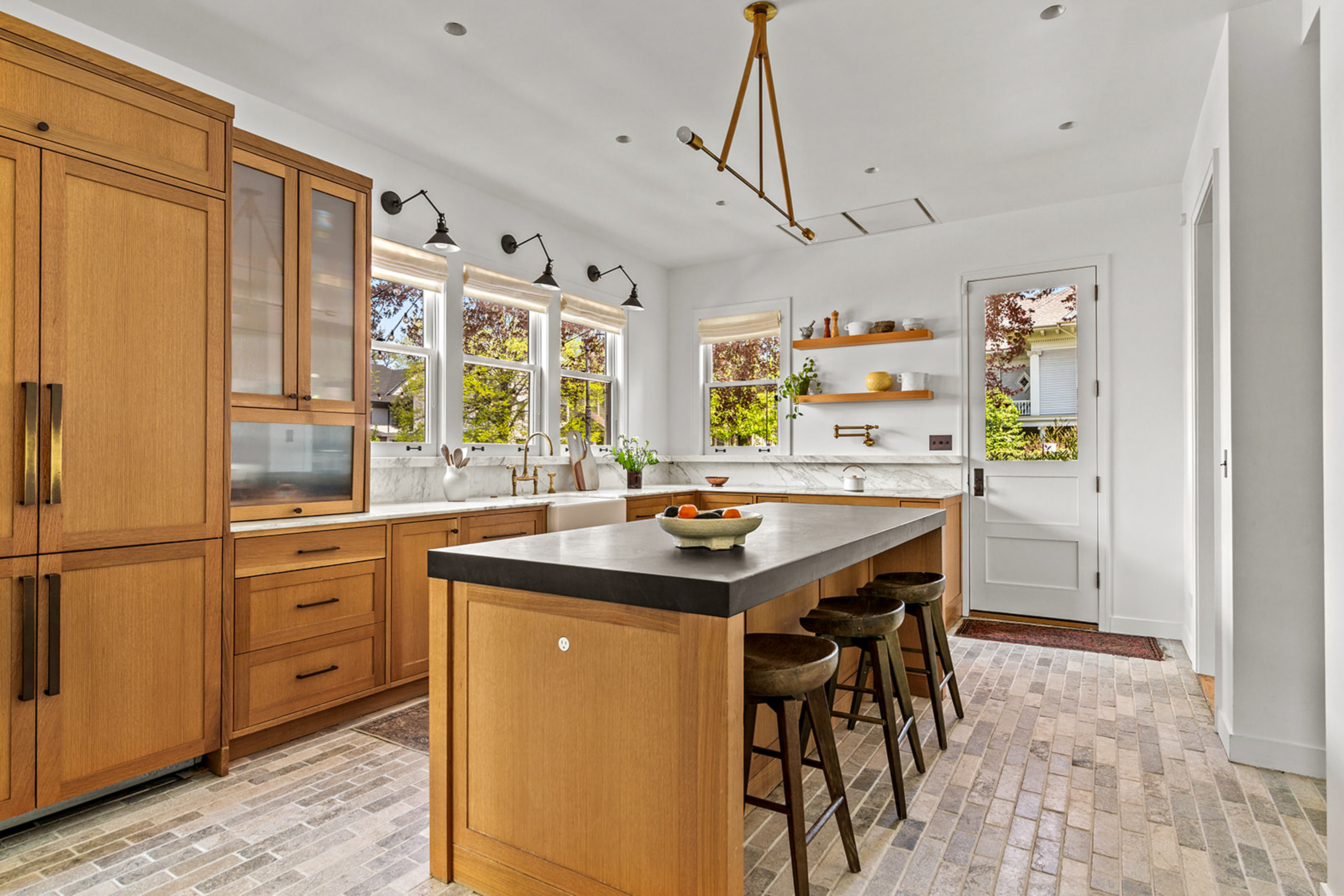 a kitchen with stainless steel appliances granite countertop a sink and a refrigerator