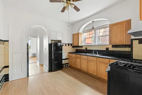 a kitchen with stainless steel appliances granite countertop a stove a sink and a refrigerator