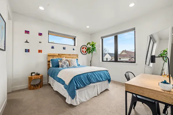 a spacious bedroom with a bed and a table in it