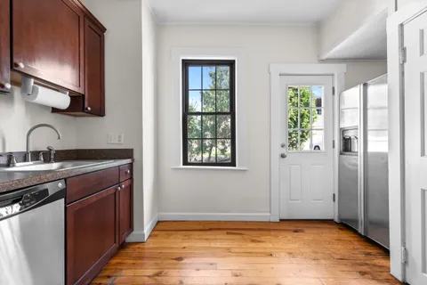 a view of a kitchen with a sink and windows