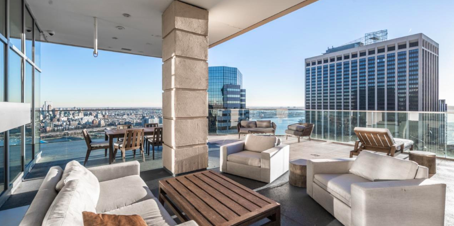 75 Wall Street, Unit 26D Manhattan, NY 10005 - Photo 8 of 11 a balcony with couch and chairs