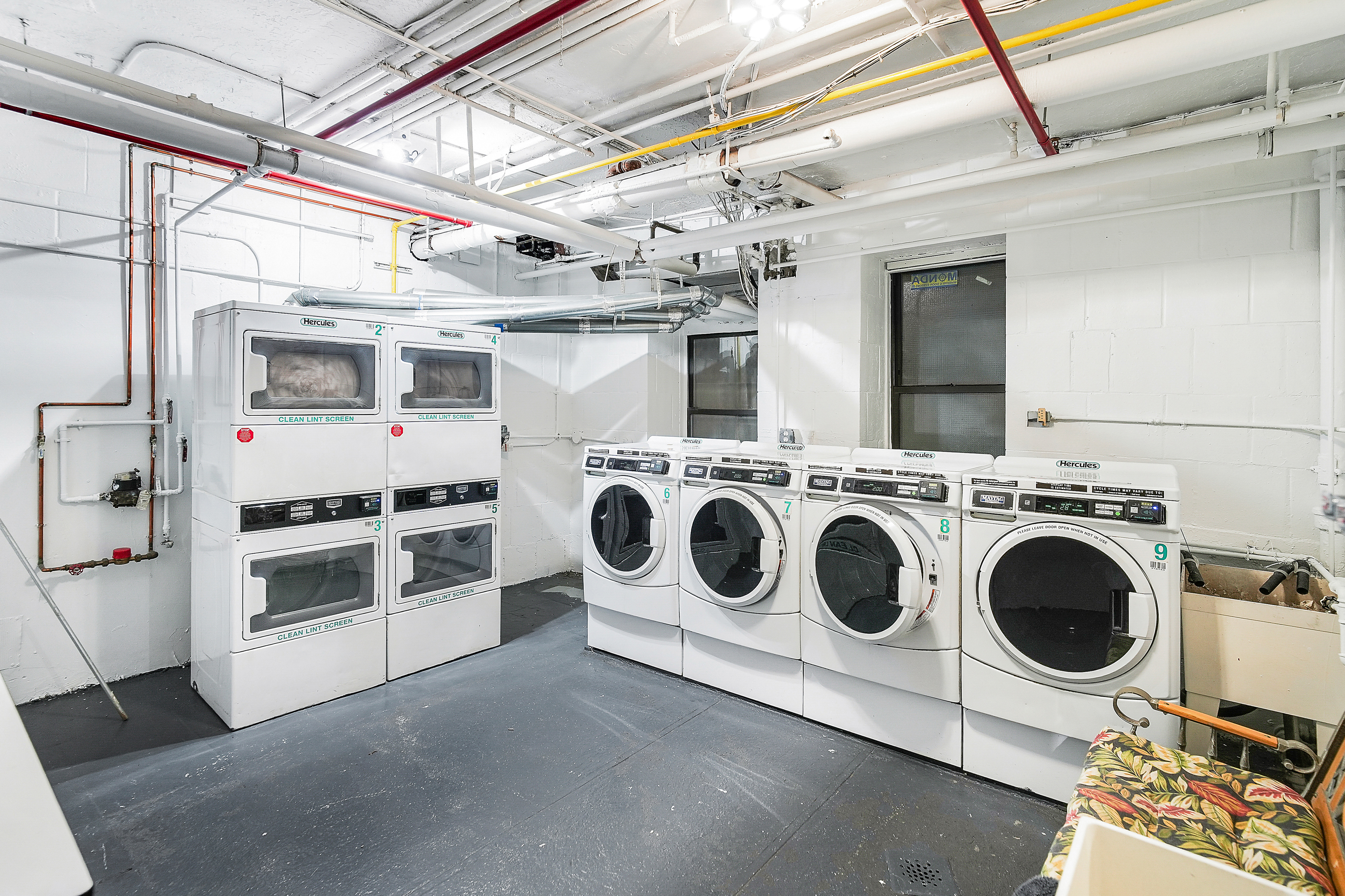 205 West 54th Street, Unit 3A Manhattan, NY 10019 - Photo 10 of 14 a utility room with dryer and washer
