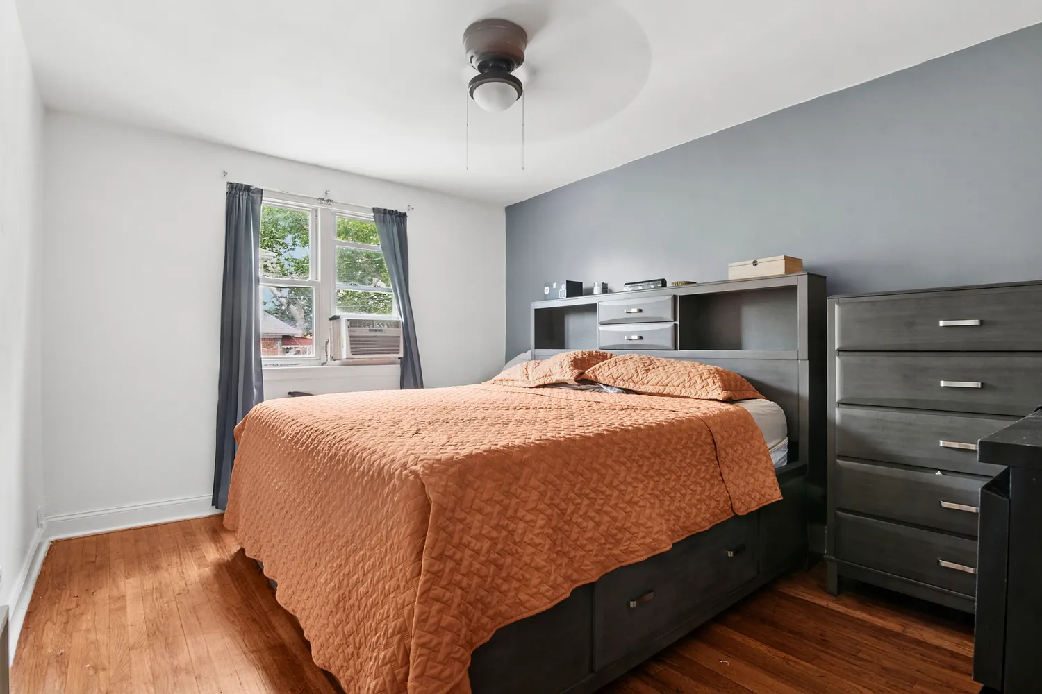 a bed sitting in a bedroom next to a window