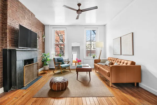 a living room with furniture fireplace and flat screen tv