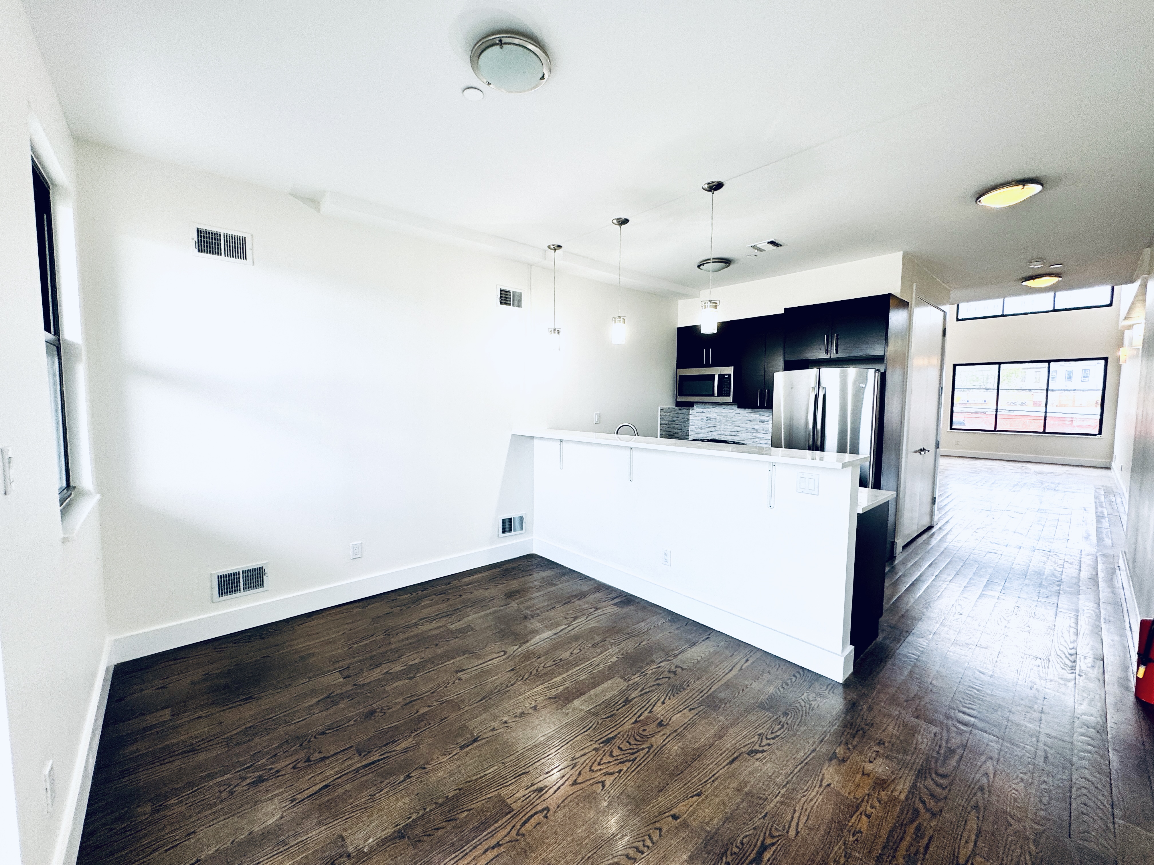 29 MacDougal Street, Unit 2 Brooklyn, NY 11233 - Photo 5 of 14 a view of a kitchen with furniture and wooden floor