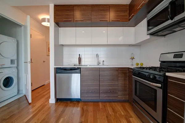a kitchen with stainless steel appliances granite countertop a stove and a refrigerator