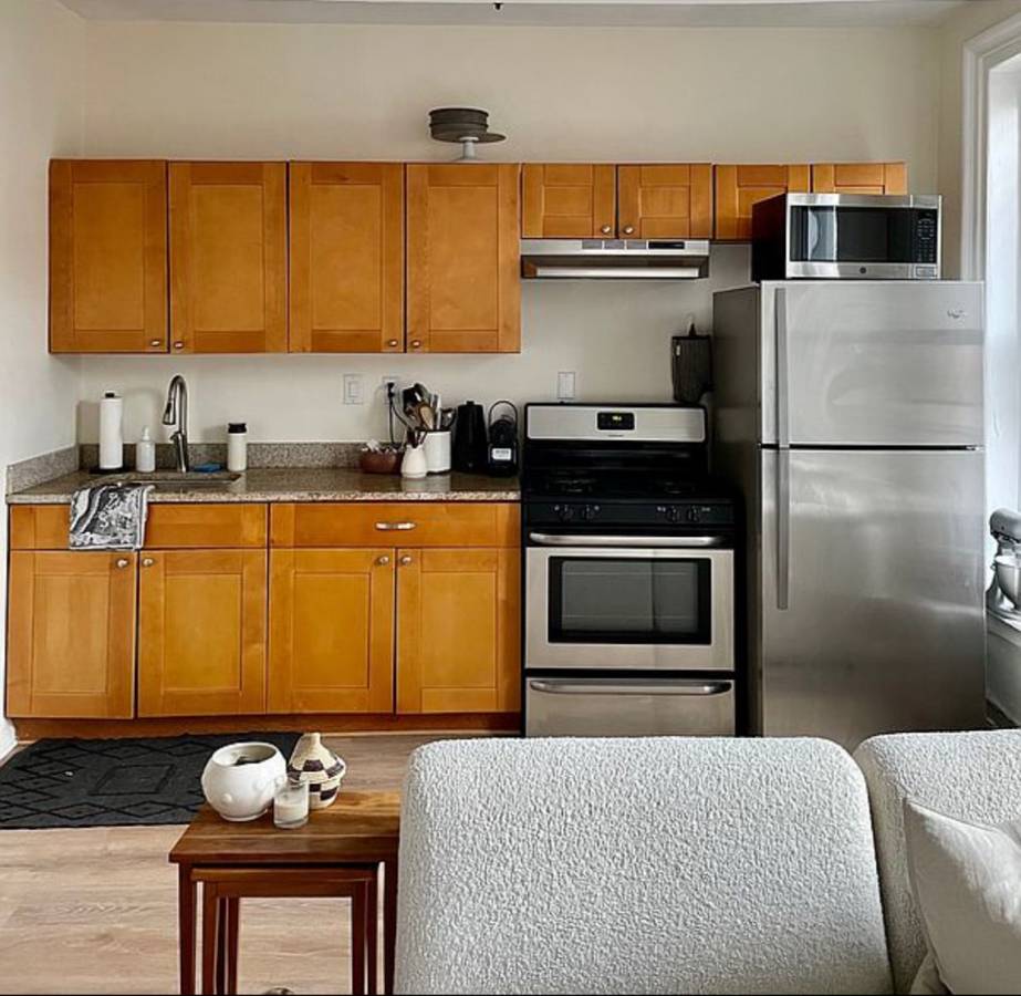 393 Clermont Avenue, Unit 3 Brooklyn, NY 11238 - Photo 6 of 10 a kitchen with stainless steel appliances granite countertop a refrigerator stove and sink