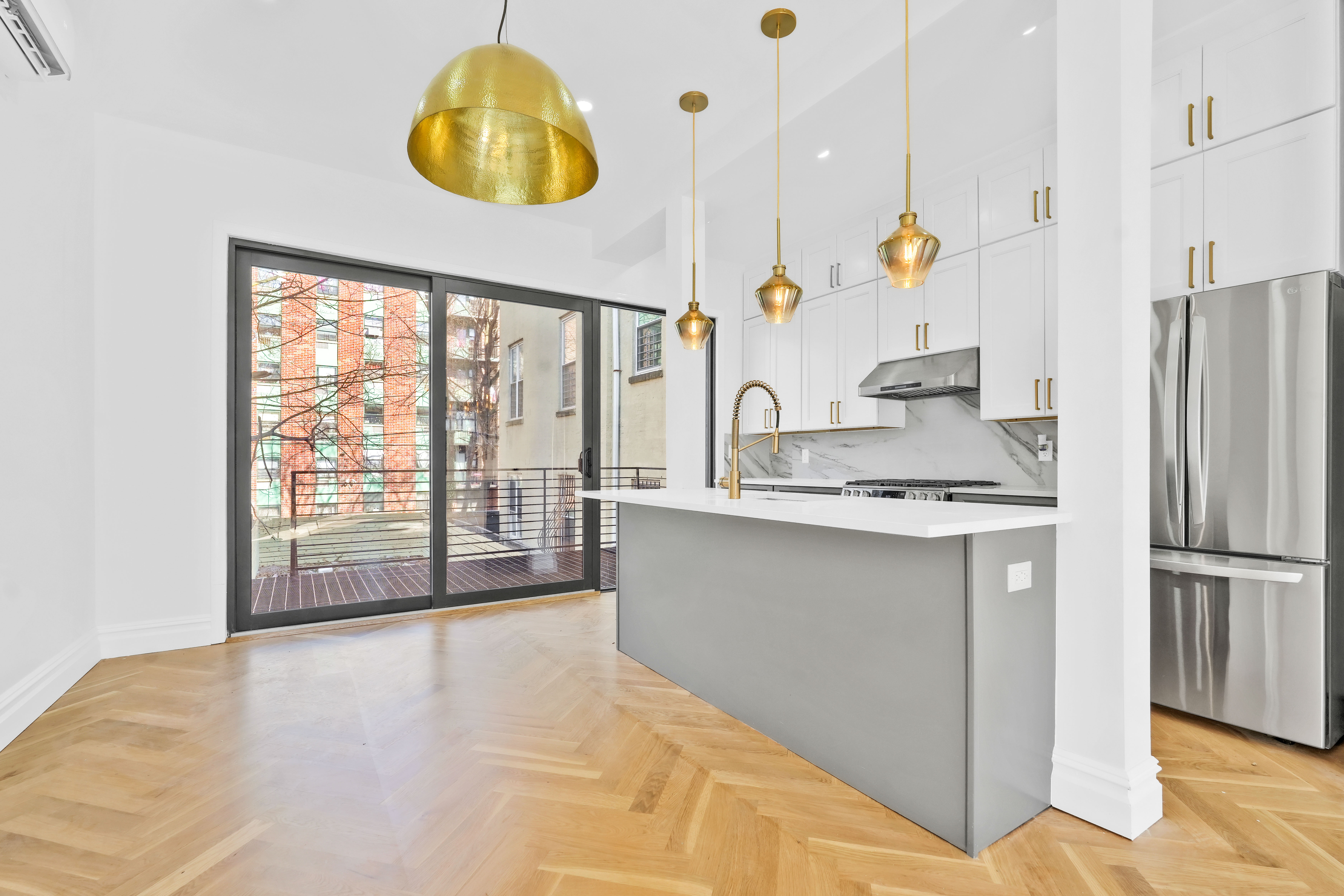473 Monroe Street Brooklyn, NY 11221 - Photo 3 of 40 a kitchen with stainless steel appliances granite countertop a sink a refrigerator and a stove