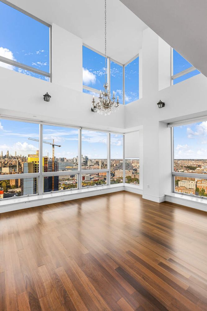 150 Myrtle Avenue, Unit PH3201 Brooklyn, NY 11201 - Photo 2 of 40 a view of a living room and kitchen with stainless steel appliances granite countertop cabinets and a wooden floor