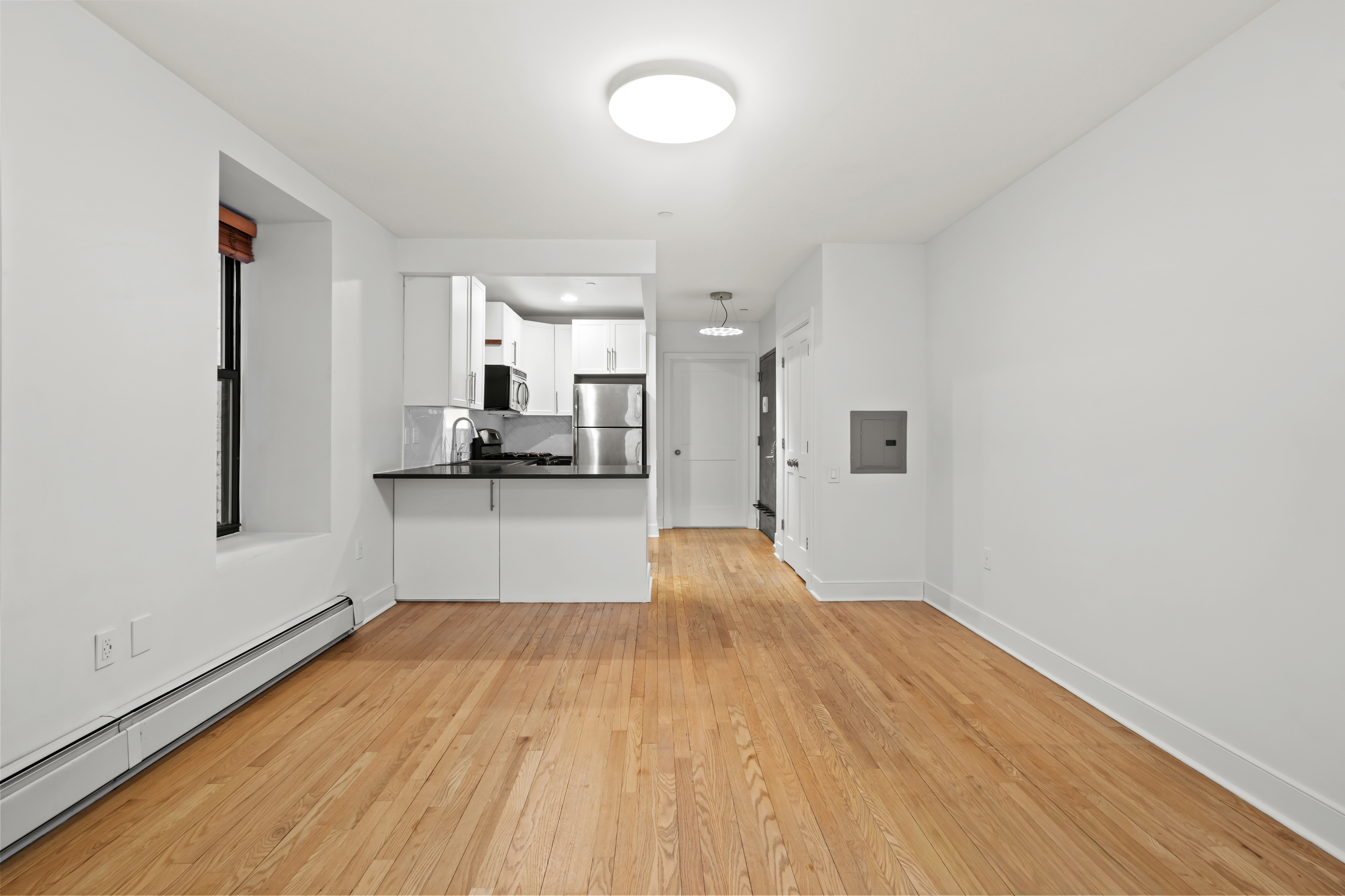 305 West 150th Street, Unit 206 Manhattan, NY 10039 - Photo 4 of 18 a view of a kitchen from the hallway