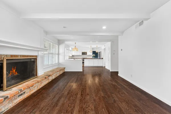 a view of a kitchen with wooden floor and a kitchen