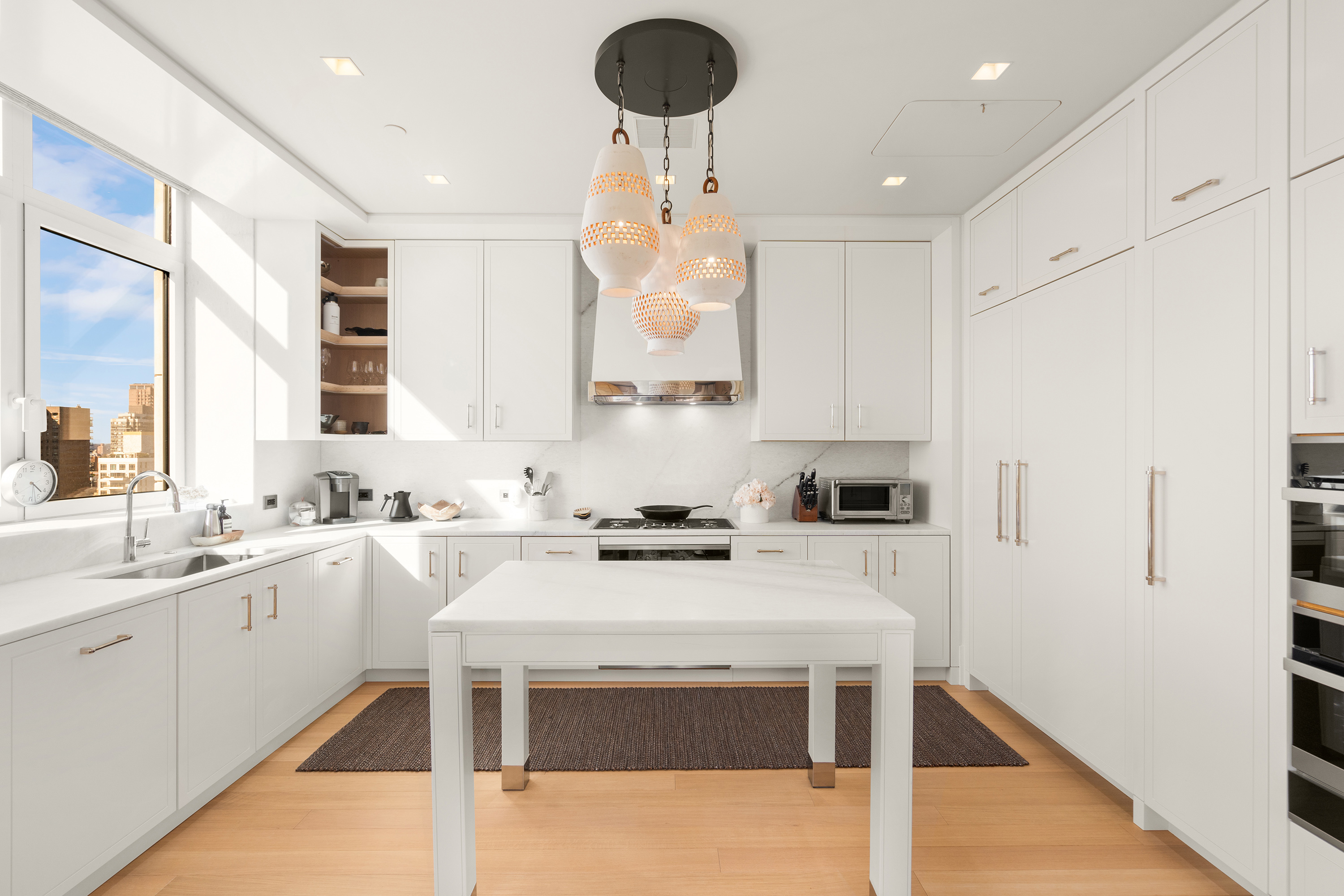 200 East 83rd Street, Unit 24C Manhattan, NY 10028 - Photo 7 of 35 a kitchen with a sink a stove a refrigerator and cabinets