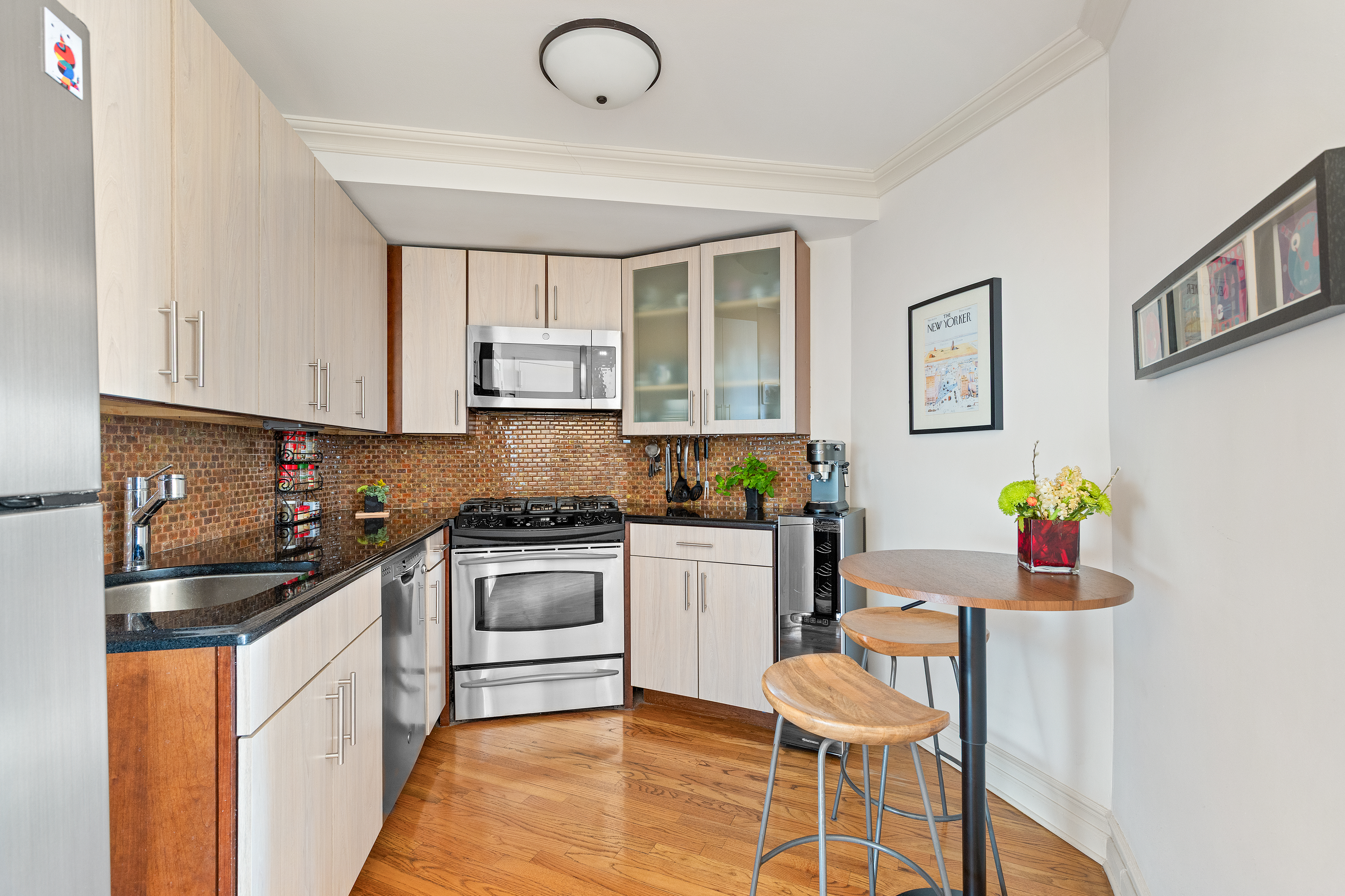 1139 Prospect Avenue, Unit 4G Brooklyn, NY 11218 - Photo 5 of 11 a kitchen with stainless steel appliances kitchen island granite countertop a sink and cabinets