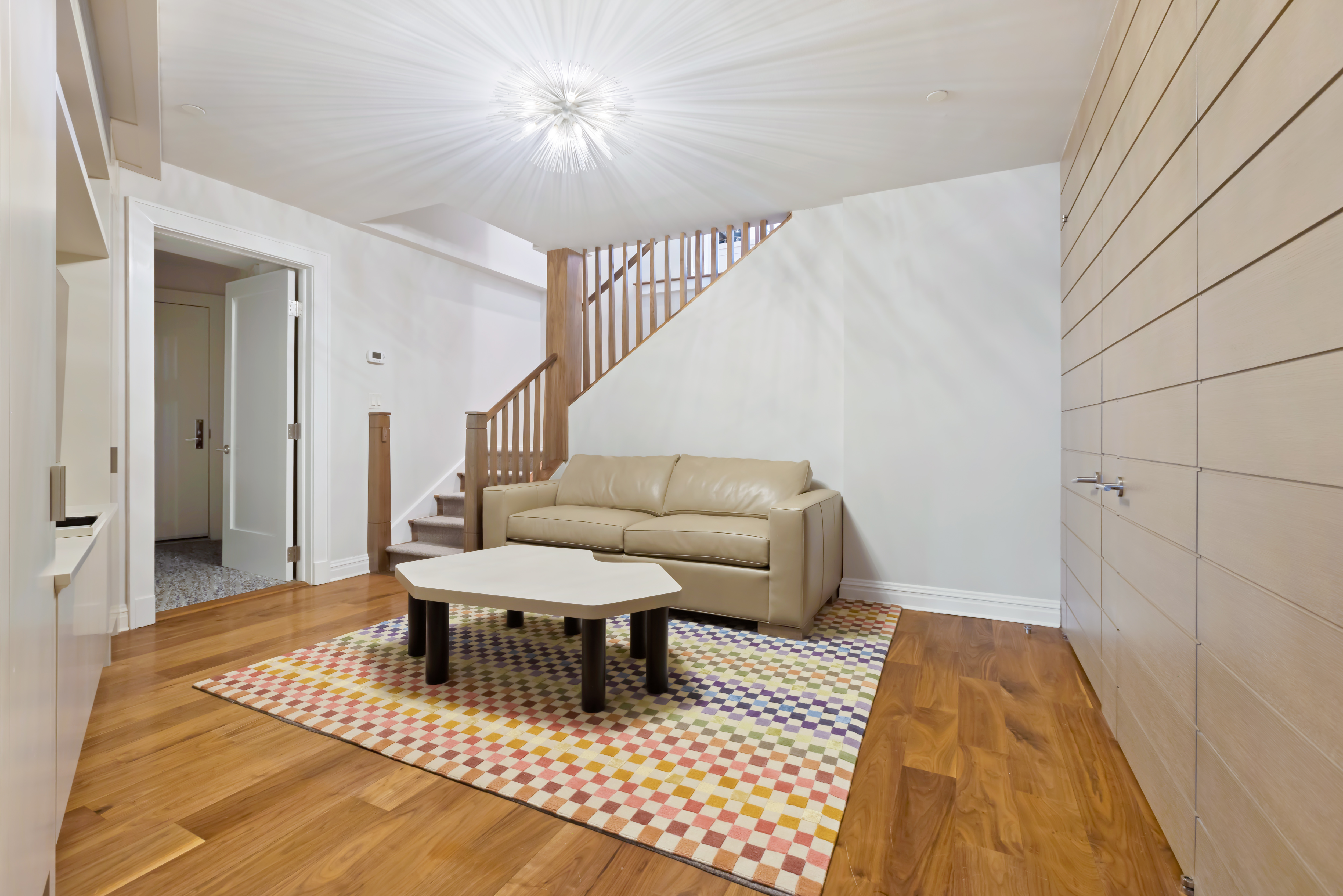161 Duane Street, Unit 4B Manhattan, NY 10013 - Photo 10 of 12 a living room with a couch and a rug