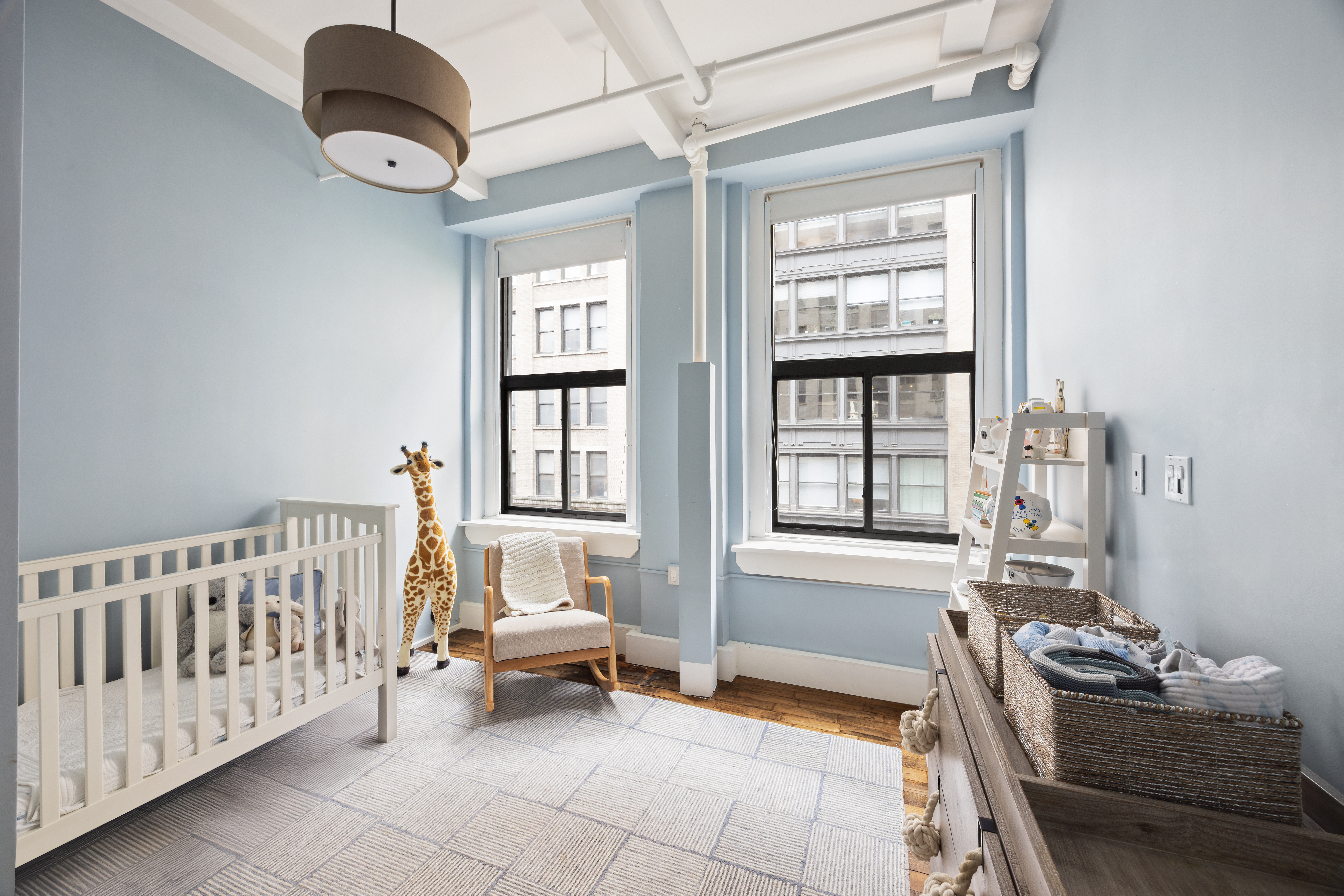 129 West 22nd Street, Unit 5A Manhattan, NY 10011 - Photo 10 of 13 a bedroom with furniture and a window
