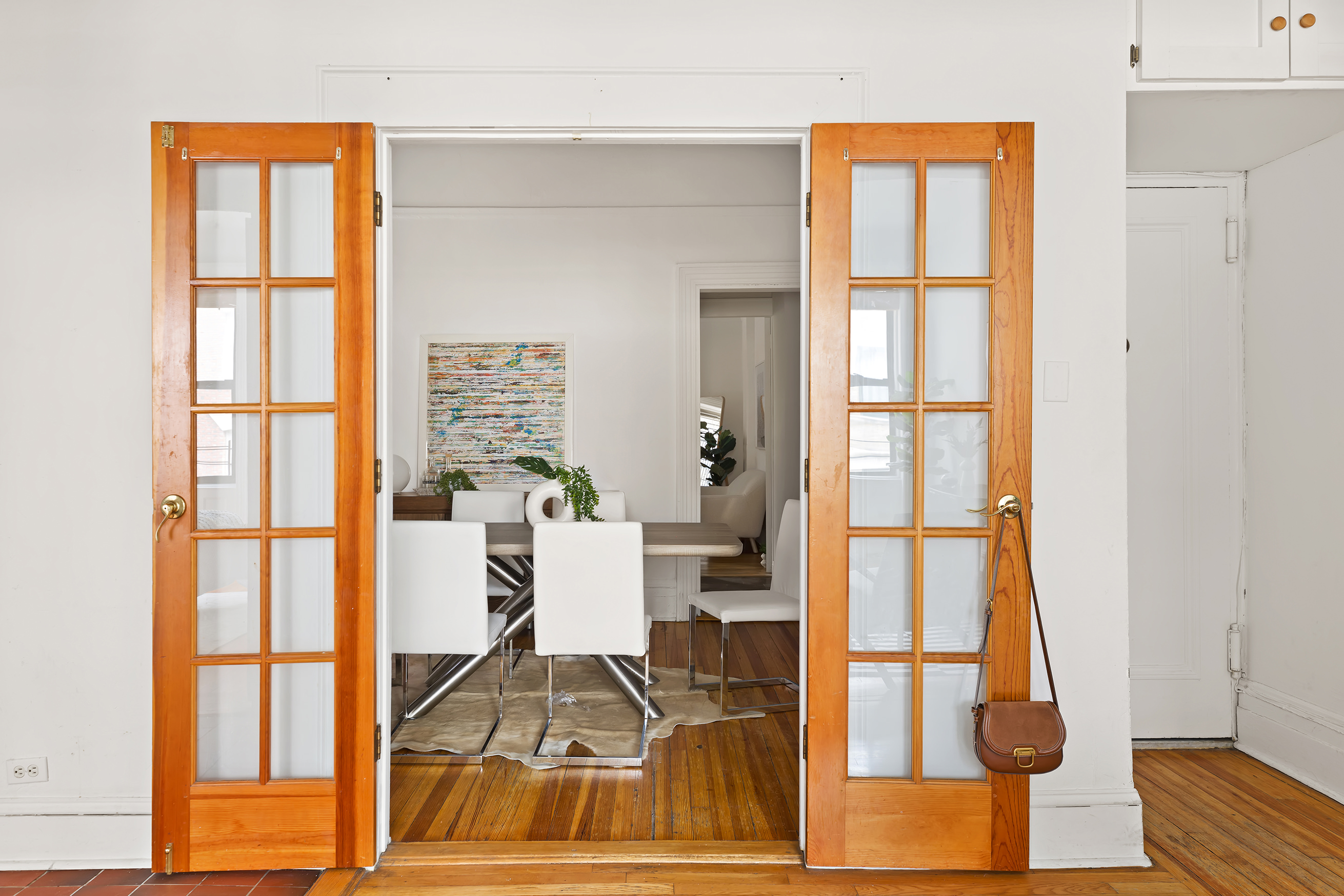 615 West 113th Street, Unit 3132 Manhattan, NY 10025 - Photo 3 of 13 a living room with furniture a dining table and a large window