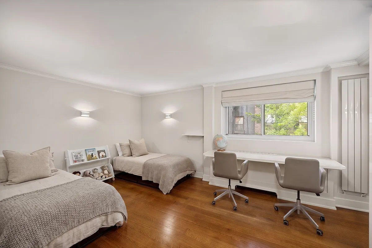 170 East 88th Street, Unit 1C Manhattan, NY 10128 - Photo 13 of 16 a bedroom with two beds and a desk