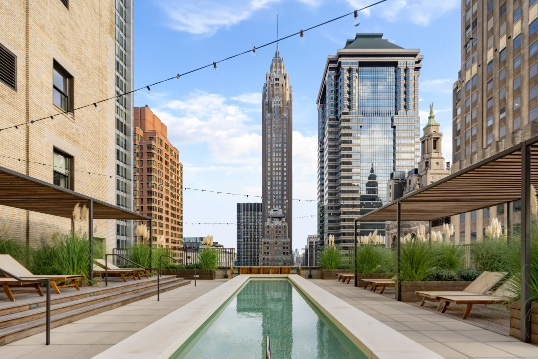 20 Pine Street, Unit 3204 Manhattan, NY 10005 - Photo 5 of 9 a city street lined with tall buildings