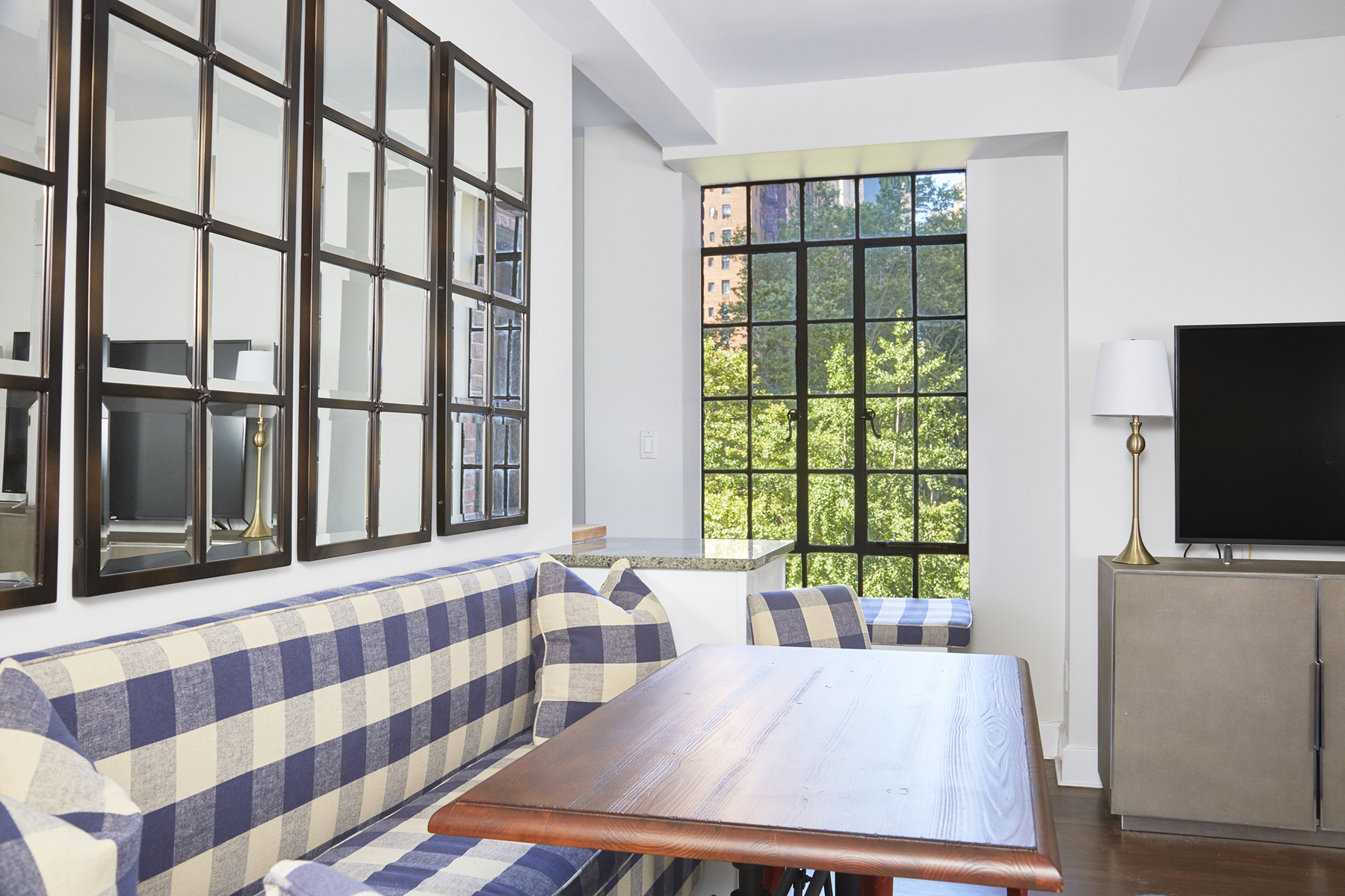 333 East 43rd Street, Unit 508 Manhattan, NY 10017 - Photo 2 of 8 a living room with furniture and a flat screen tv