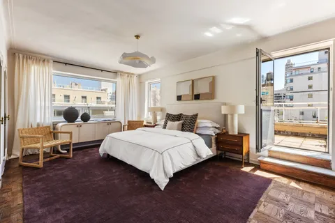 a bedroom with a large bed and a window