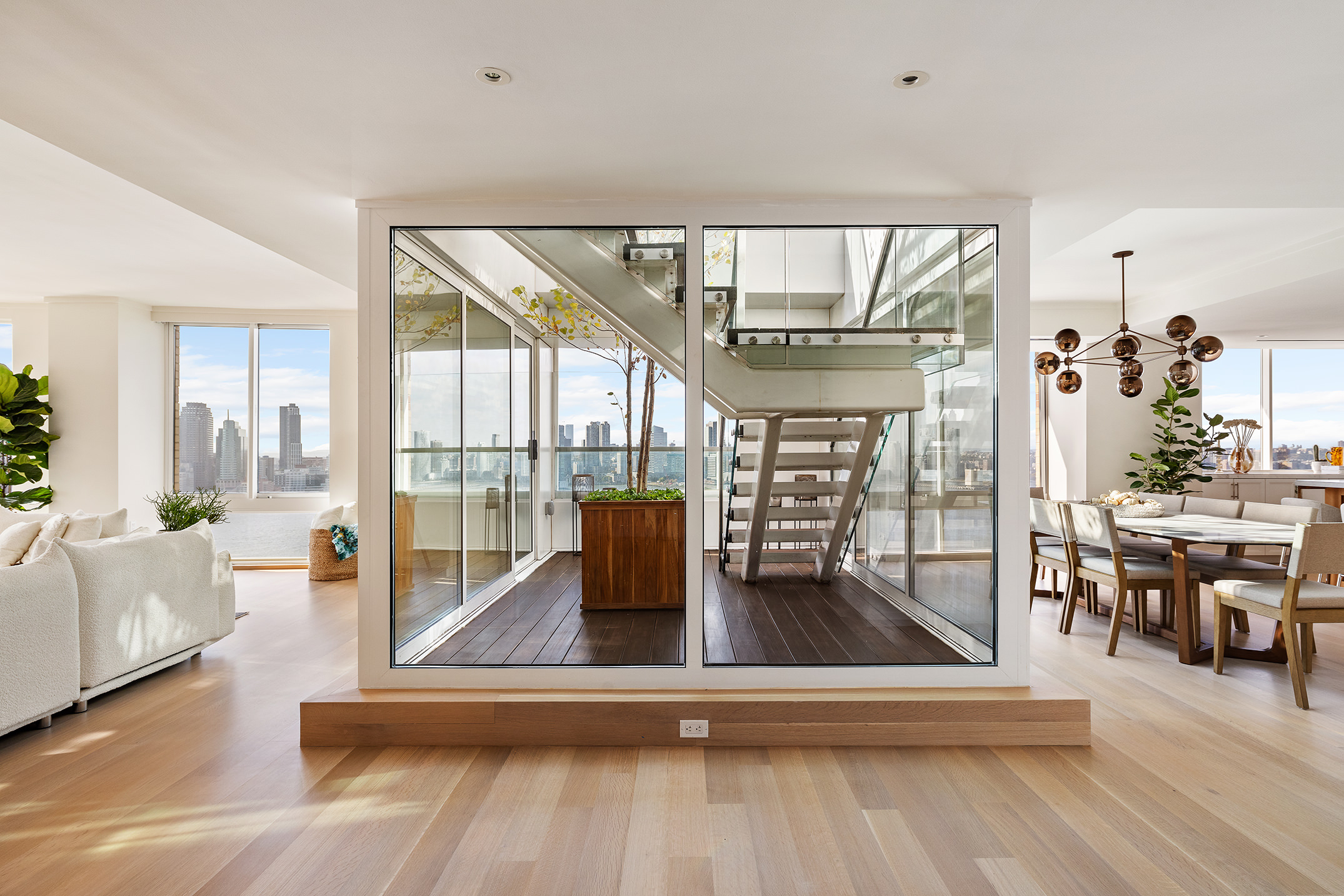 212 Warren Street, Unit PHS Manhattan, NY 10282 - Photo 4 of 18 a living room with furniture and a large window