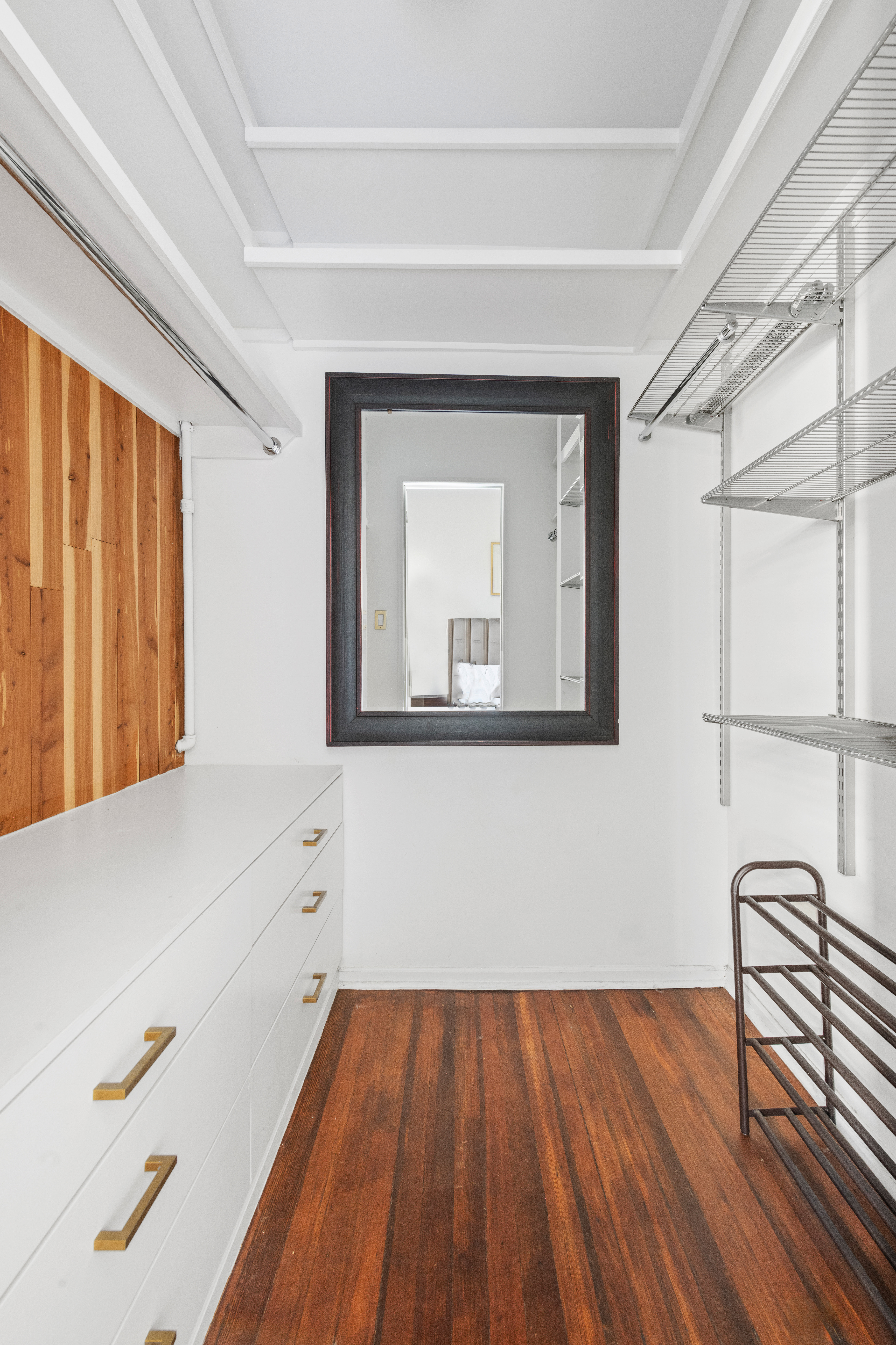 210 West 21st Street, Unit 6RE Manhattan, NY 10011 - Photo 7 of 13 a hallway with a large window and wooden floor