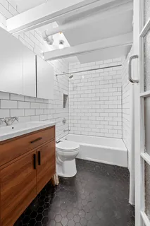 a bathroom with a sink a toilet and bathtub