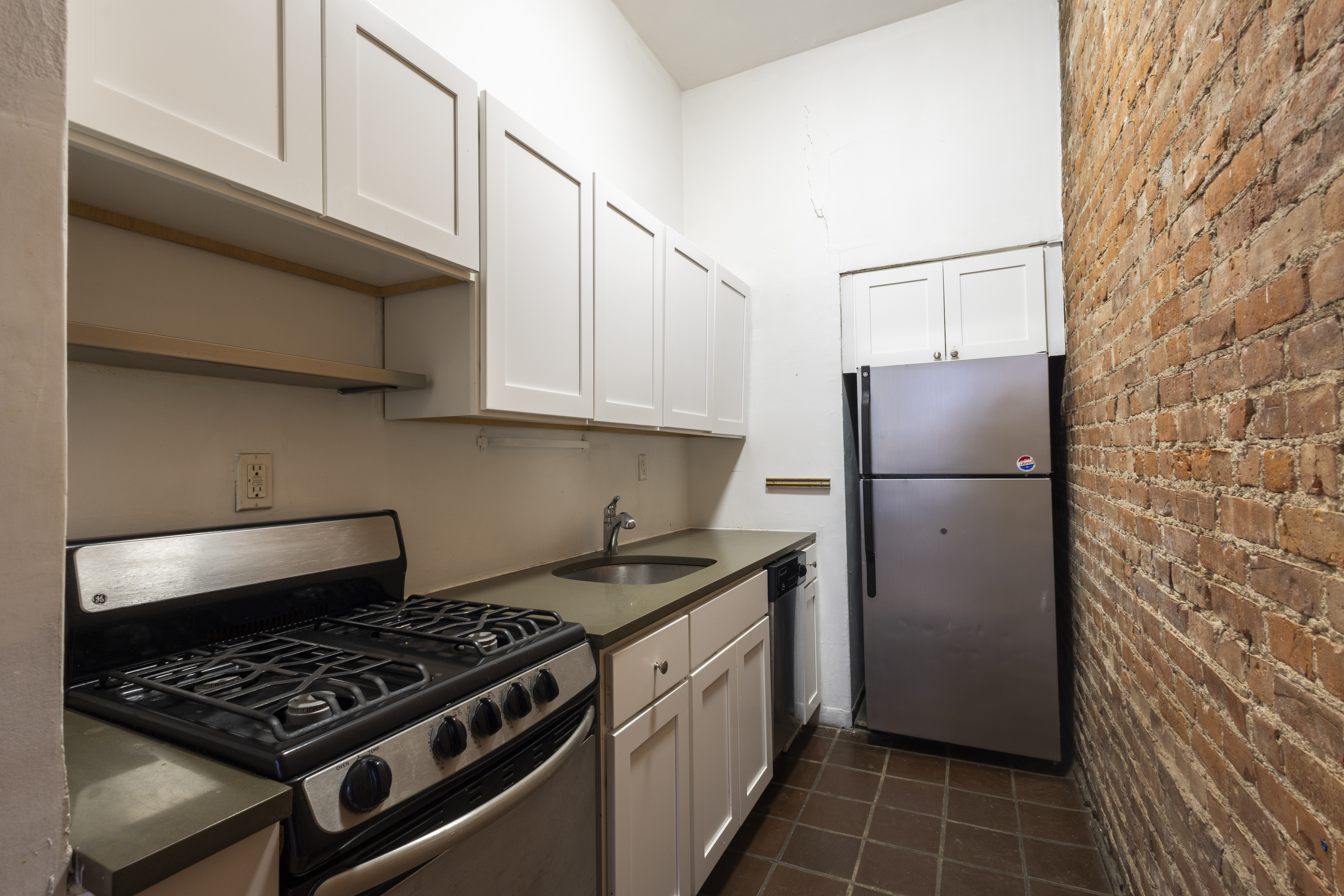 145 State Street, Unit 1 Brooklyn, NY 11201 - Photo 5 of 12 a kitchen with a stove a refrigerator and cabinets