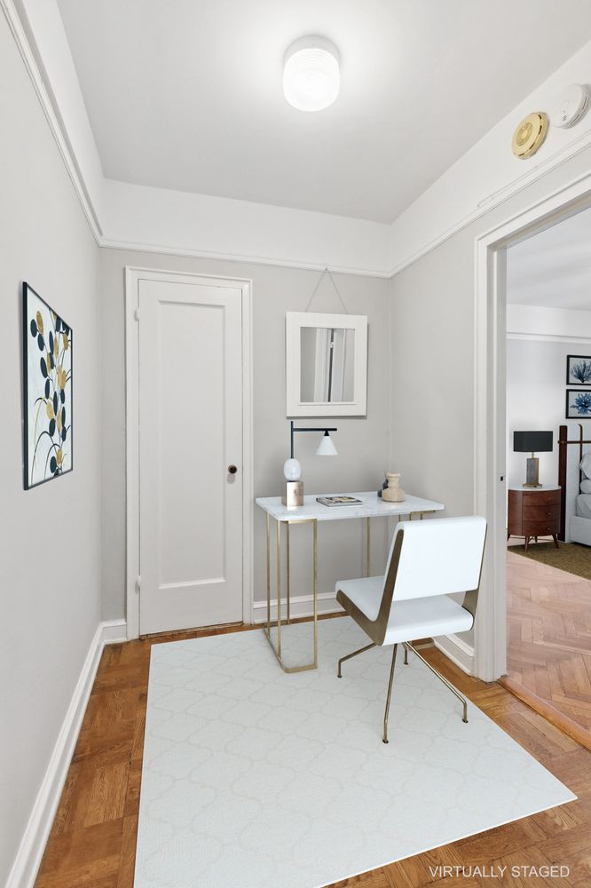 a room with table chairs and wooden floor