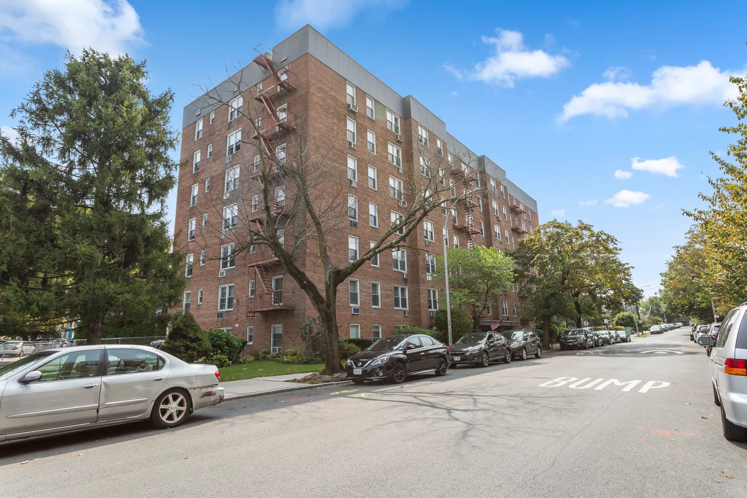 a view of a cars parked on the side of a street