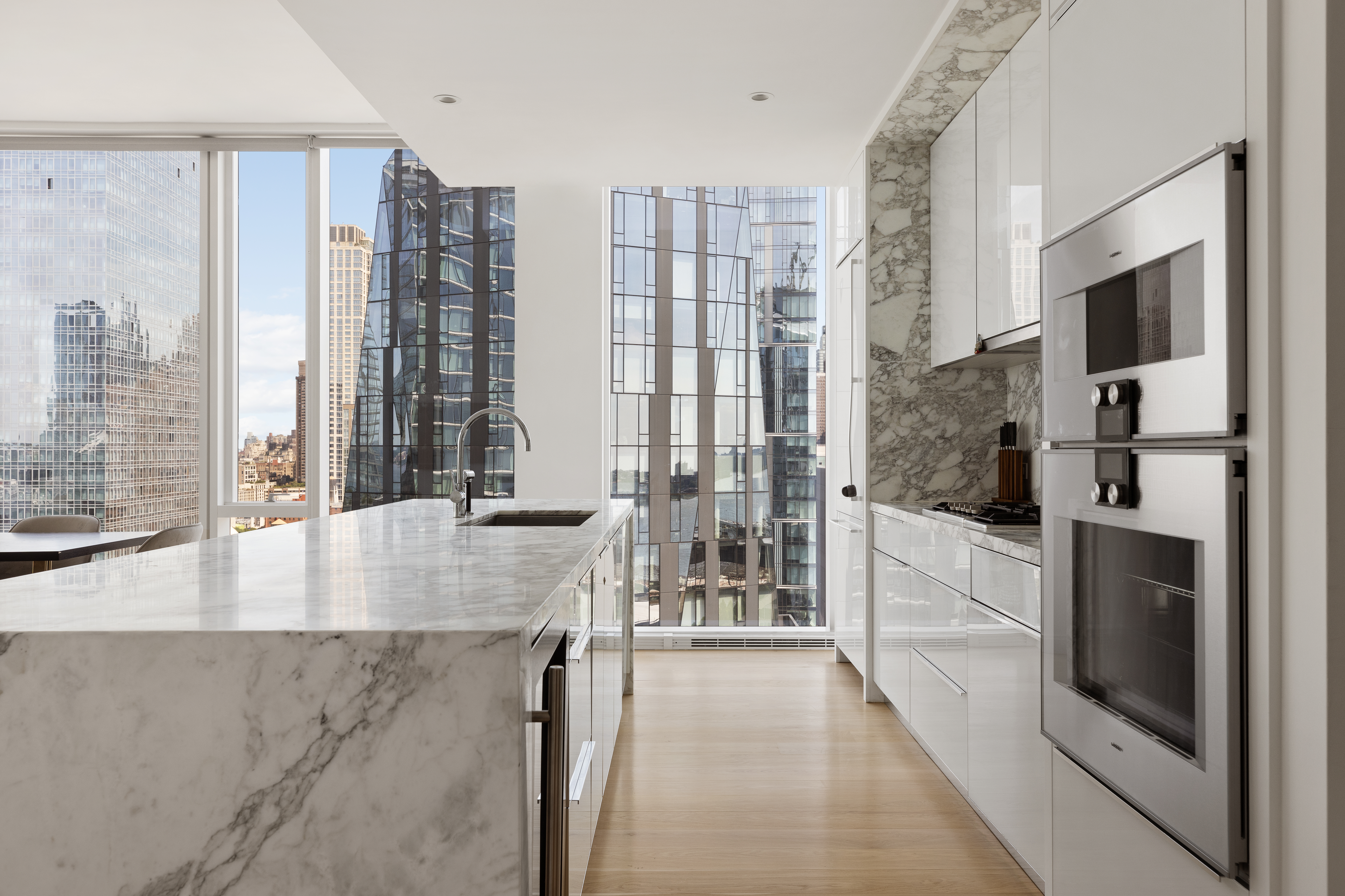 10 Riverside Boulevard, Unit 27D Manhattan, NY 10069 - Photo 3 of 21 a view of open kitchen with granite countertop a refrigerator a oven and a large window