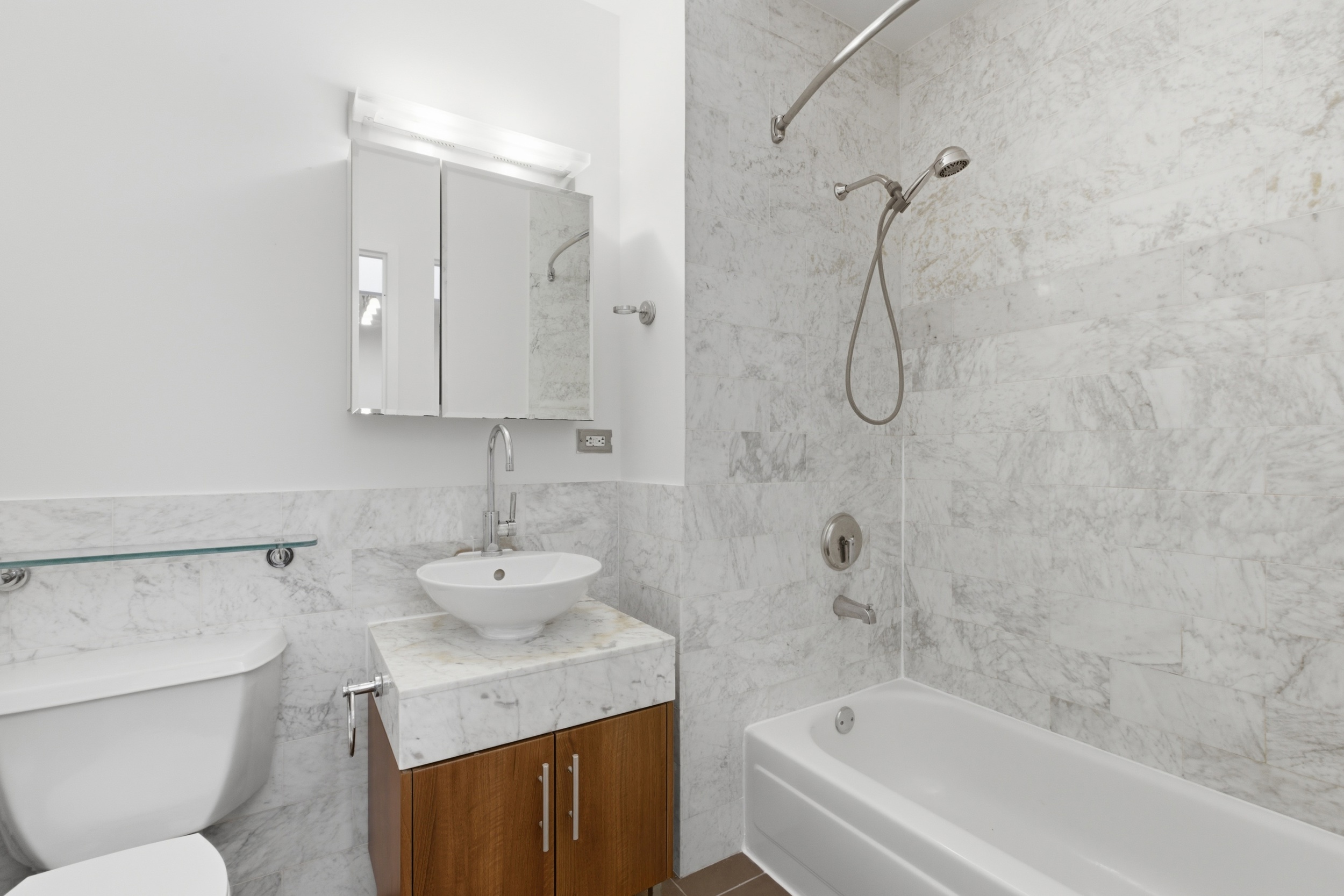 1 Wall Street Court, Unit 406 Manhattan, NY 10005 - Photo 6 of 7 a bathroom with a sink toilet and shower