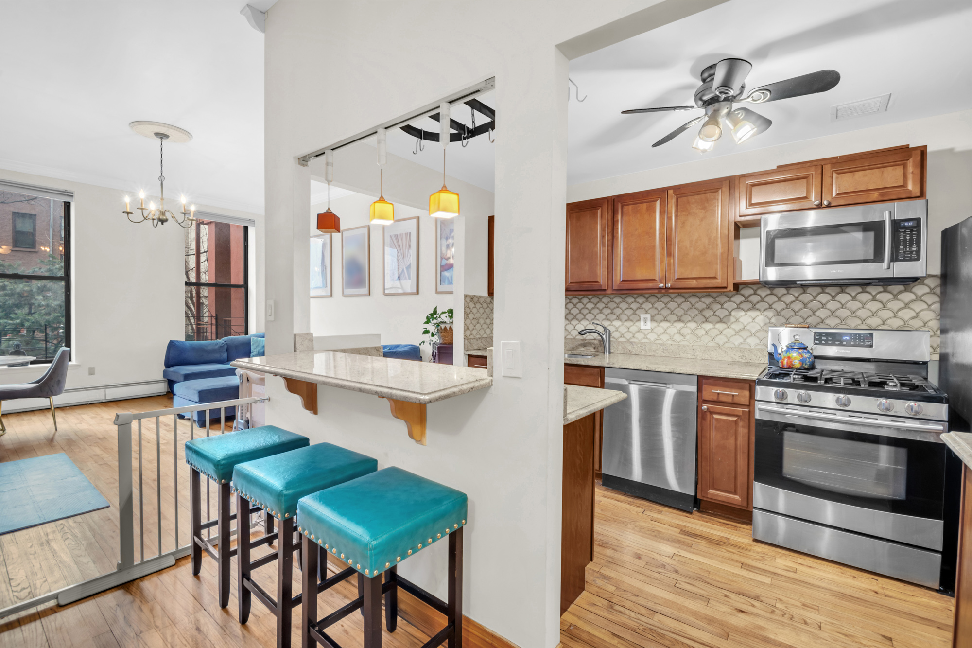 137 West 126th Street, Unit 1 Manhattan, NY 10027 - Photo 3 of 12 a kitchen with stainless steel appliances a stove a sink and a refrigerator