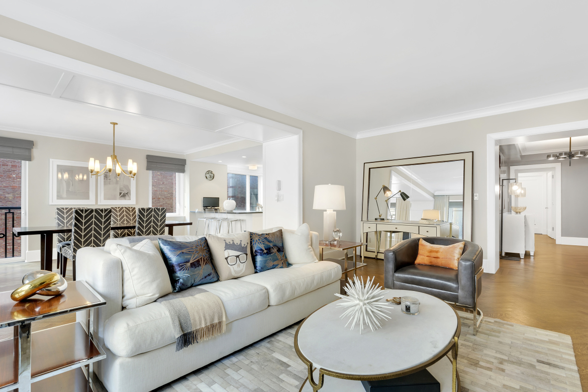 530 Park Avenue, Unit 4A Manhattan, NY 10065 - Photo 3 of 16 a living room with furniture and a dining table with wooden floor