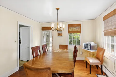 a bedroom with wooden floor and a window
