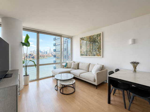 22 North 6th Street, Unit 23K Brooklyn, NY 11249 - Photo 1 of 11 a living room with furniture and a flat screen tv