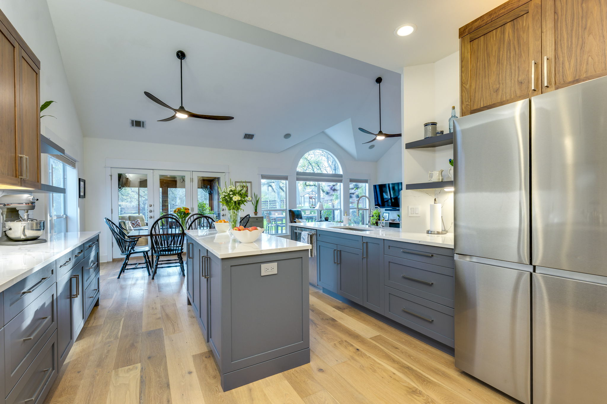 109 West Spring Drive Austin, TX 78746 - Photo 10 of 22 a kitchen with kitchen island a counter top space a sink stainless steel appliances and cabinets