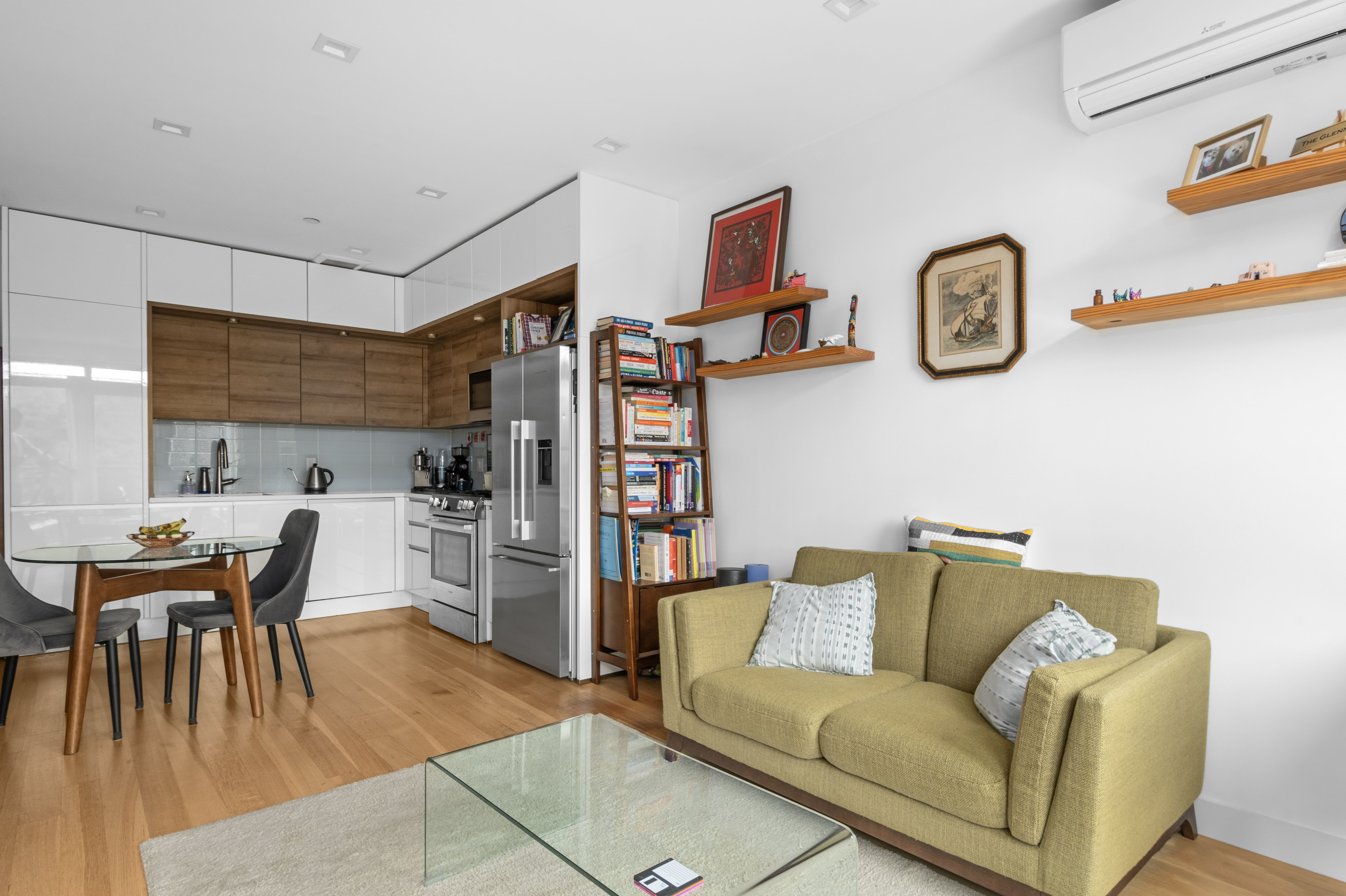 203 Quincy Street, Unit 4B Brooklyn, NY 11216 - Photo 4 of 11 a living room with furniture and a kitchen area with wooden floor