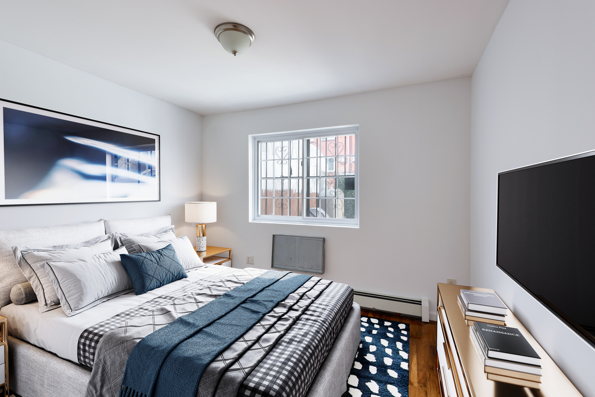 54 Lott Street, Unit 2 Brooklyn, NY 11226 - Photo 4 of 9 a bedroom with bed and a window