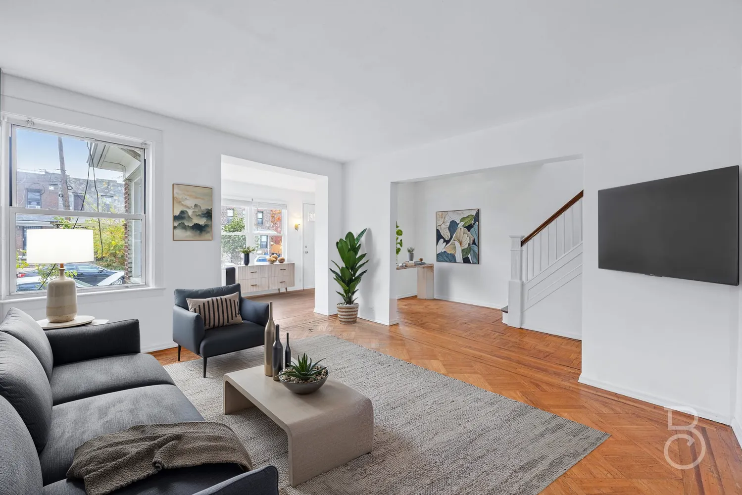 a living room with furniture and wooden floor