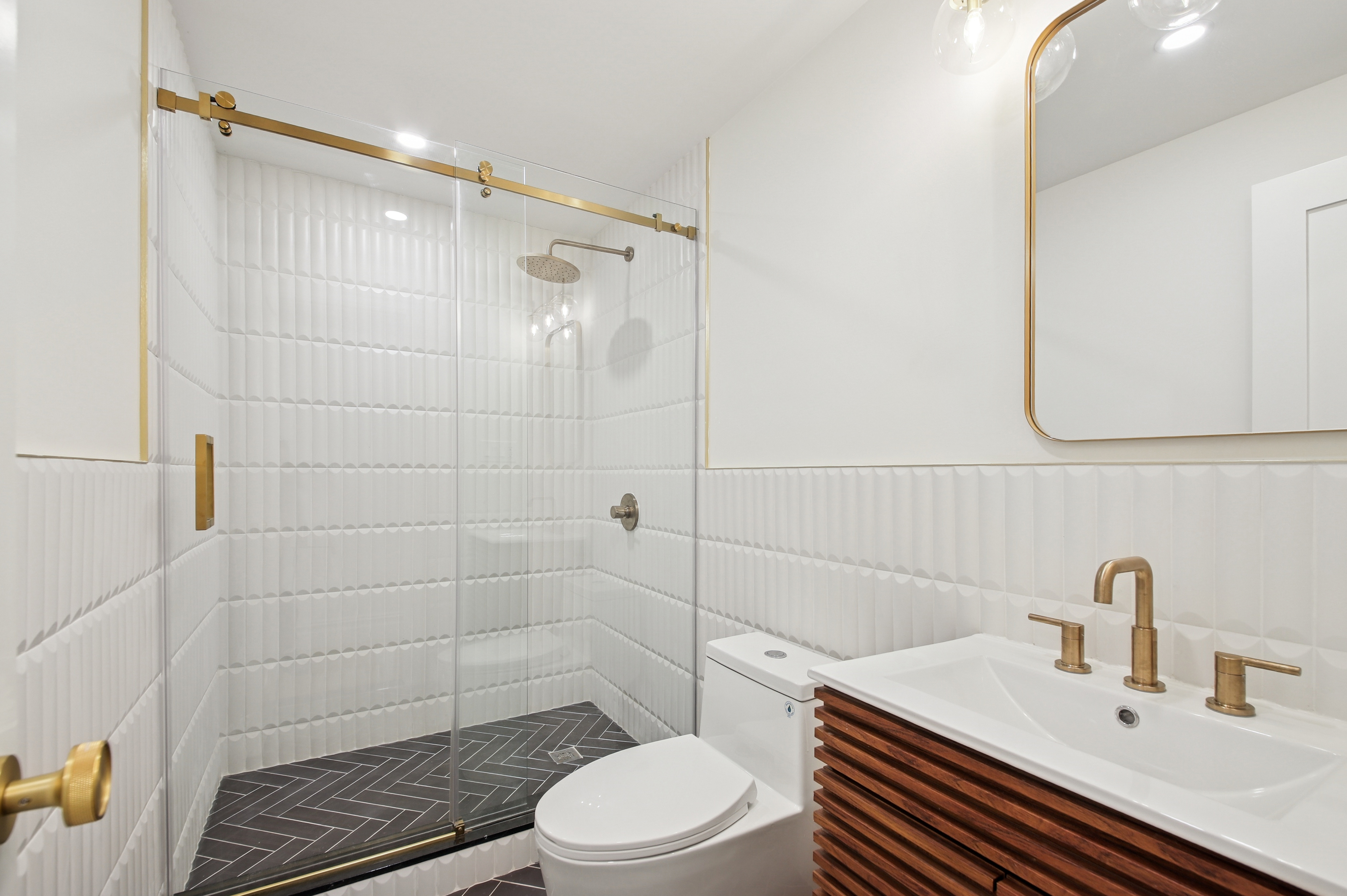 239 Madison Street, Unit 1 Brooklyn, NY 11216 - Photo 8 of 14 a bathroom with a sink a toilet and shower