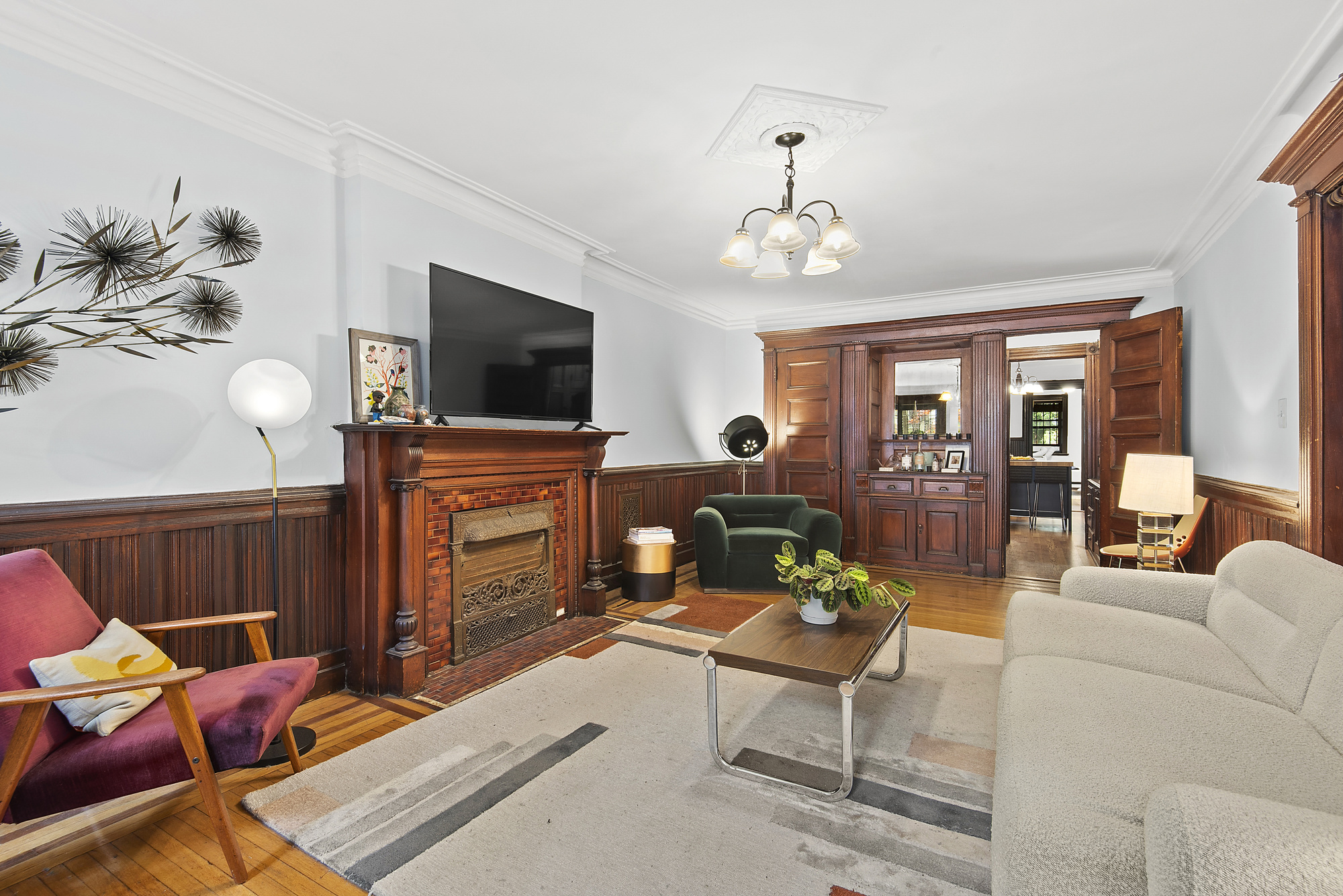 291 Sterling Place Brooklyn, NY 11238 - Photo 14 of 19 a living room with furniture a flat screen tv and kitchen view