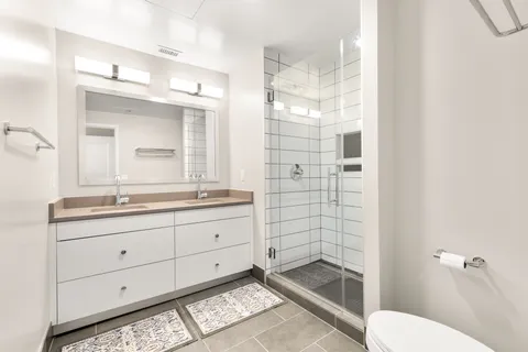 a bathroom with a shower toilet sink and mirror