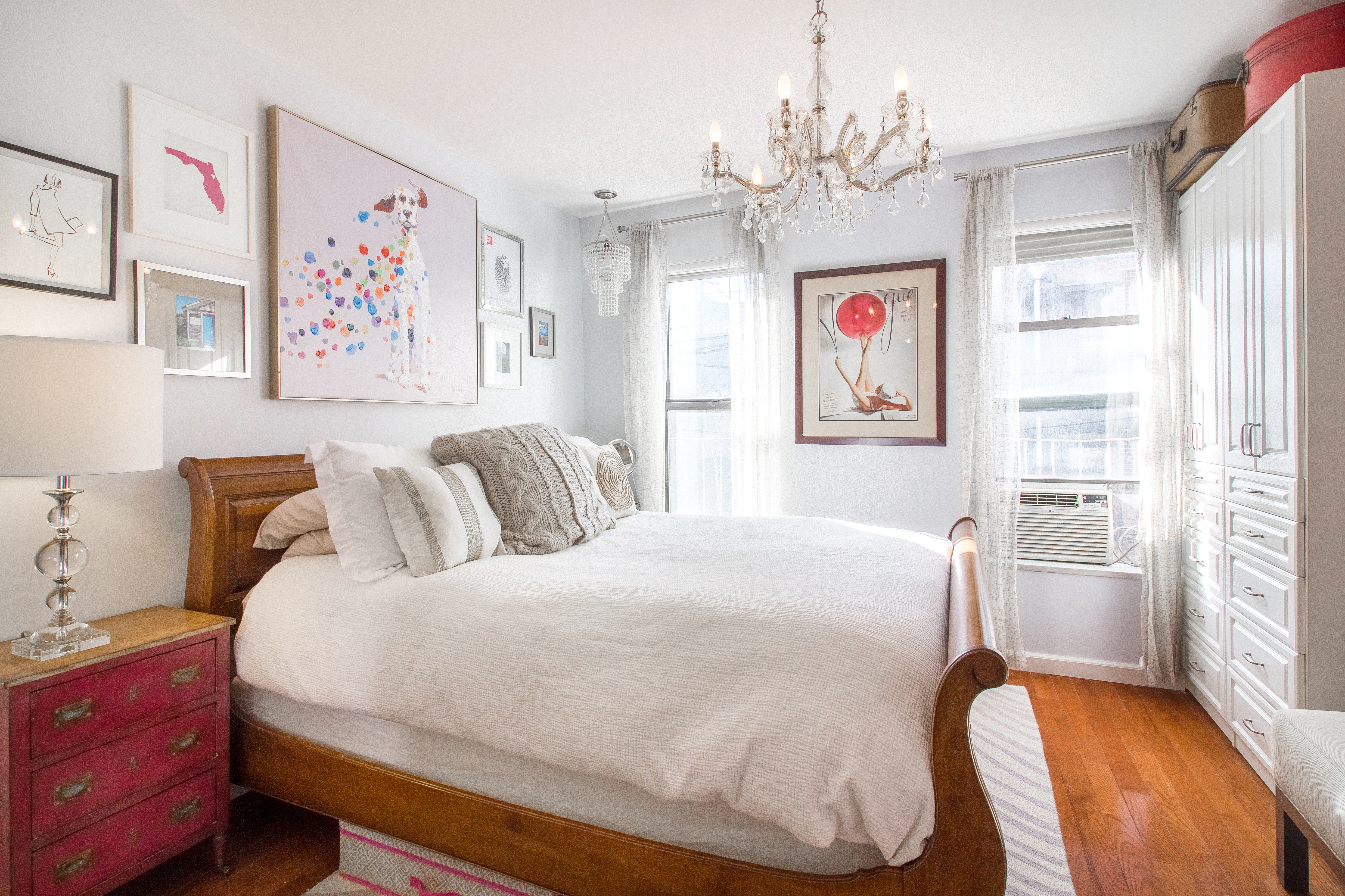 246 East 90th Street, Unit 5C Manhattan, NY 10128 - Photo 7 of 13 a spacious bedroom with a bed and a chandelier