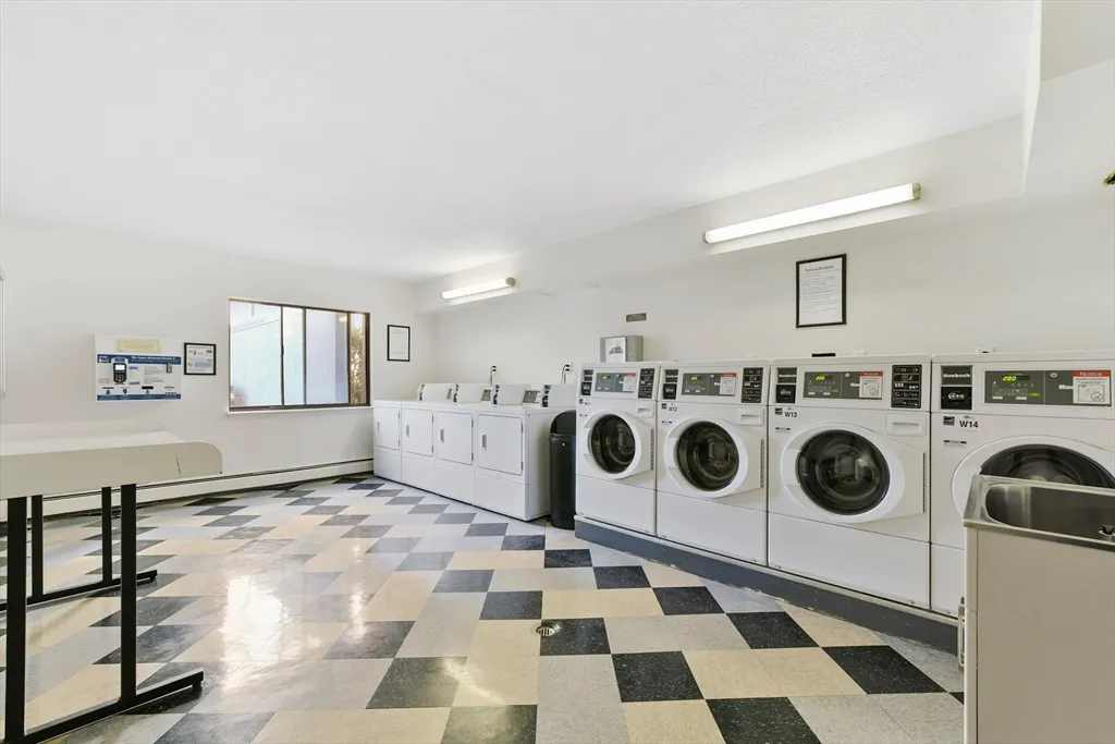 a utility room with a stove a sink and dishwasher