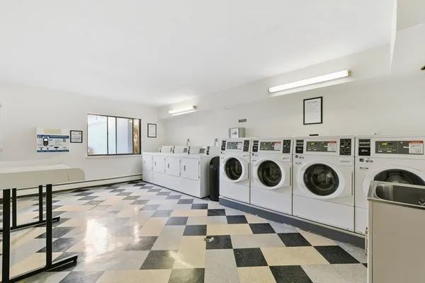 a utility room with a stove a sink and dishwasher