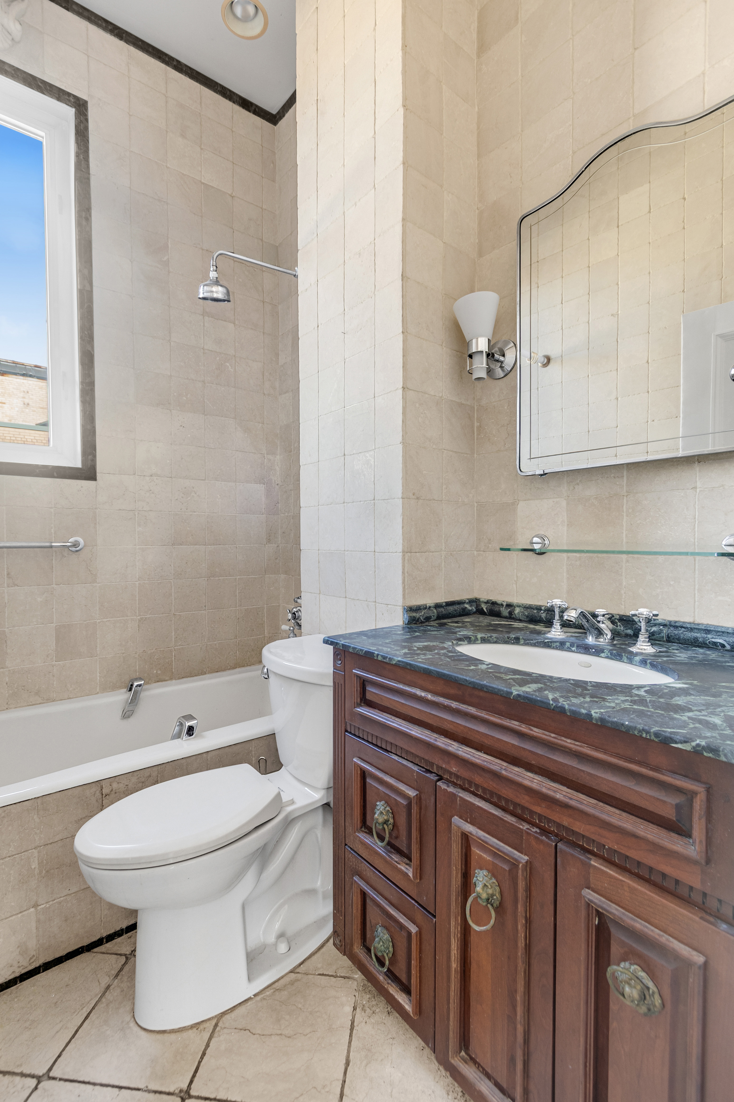 470 West End Avenue, Unit PH-G New York, NY 10024 - Photo 19 of 22 a bathroom with a granite countertop toilet a sink and a mirror