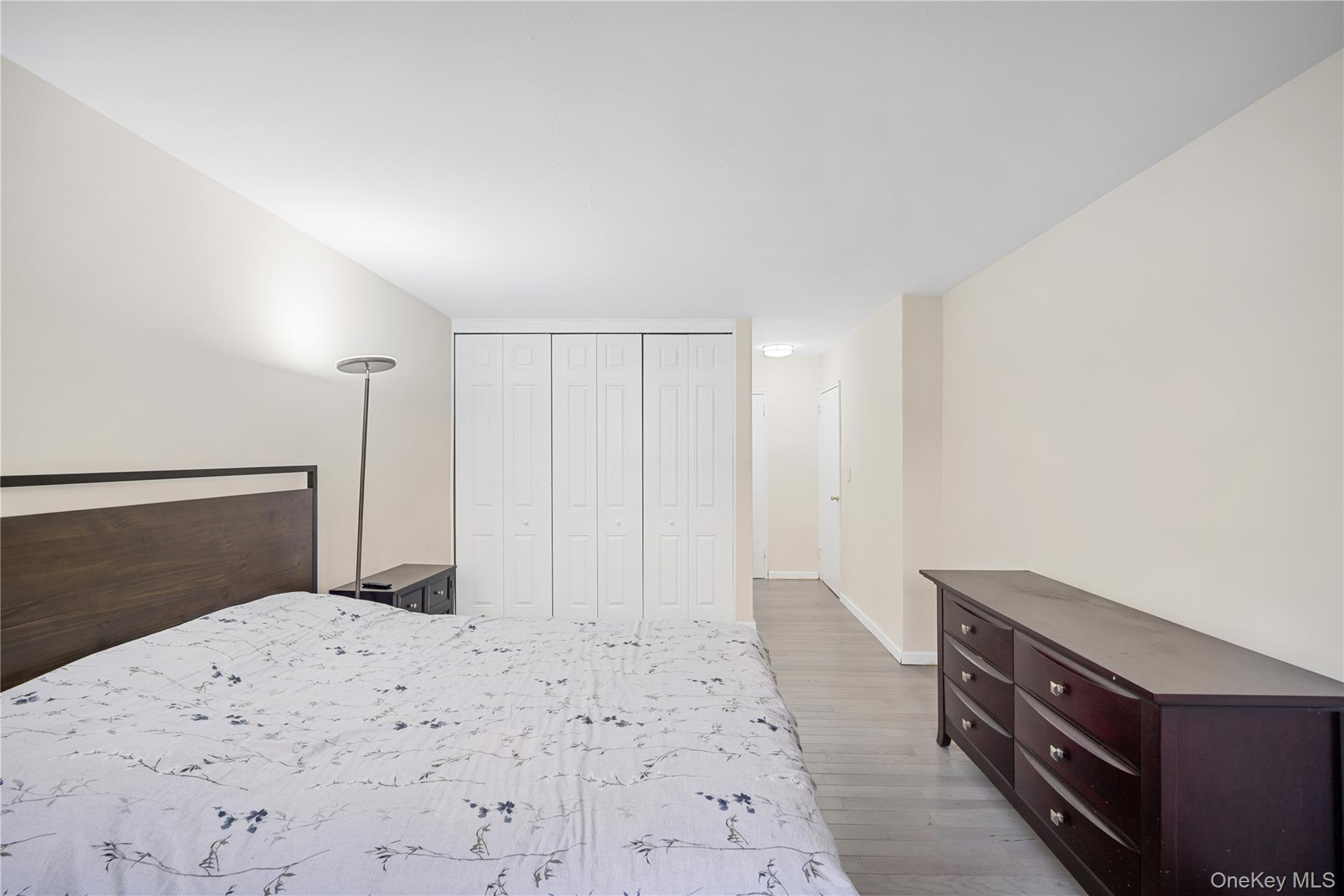75-34 Bell Boulevard, Unit LD Queens, NY 11364 - Photo 20 of 26 a bedroom with a bed and a bathroom in it