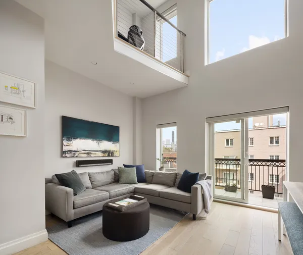 a living room with furniture wooden floor and a flat screen tv